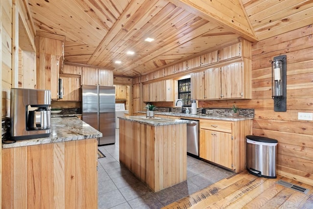 kitchen featuring wooden ceiling, wooden walls, stainless steel appliances, and a kitchen island