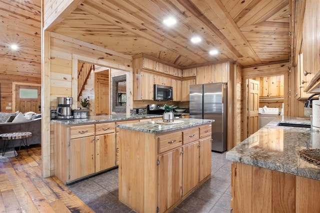 kitchen with a center island, stainless steel appliances, dark stone countertops, wooden walls, and wooden ceiling