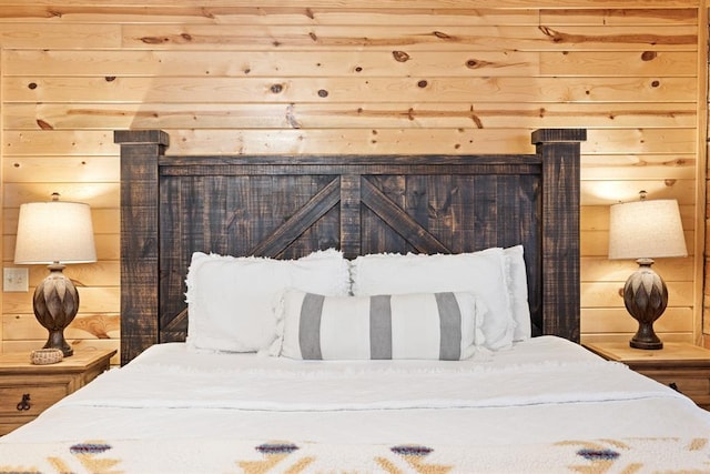 bedroom featuring wood walls