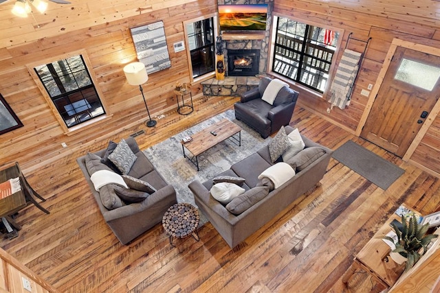 living room with ceiling fan and a fireplace