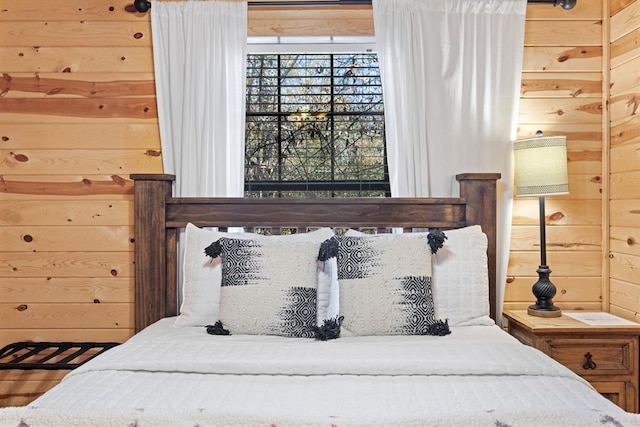 bedroom featuring wooden walls