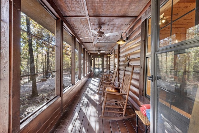 unfurnished sunroom featuring ceiling fan and wooden ceiling