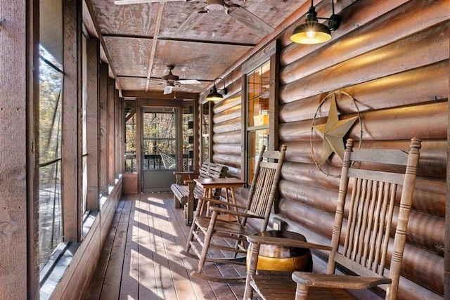 unfurnished sunroom with ceiling fan and wooden ceiling