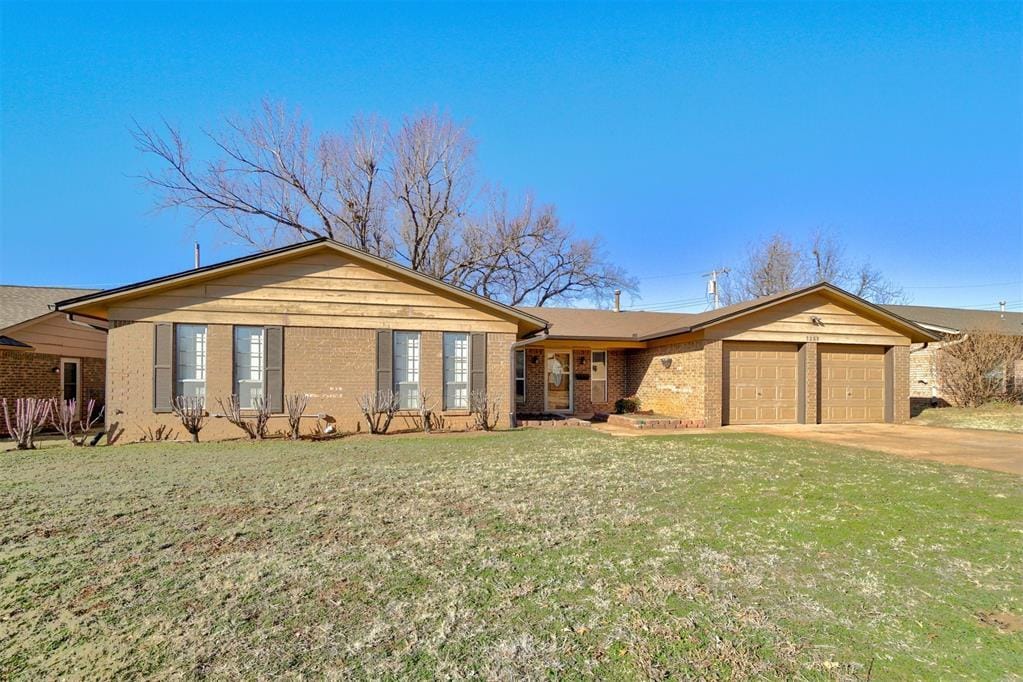 ranch-style home featuring a front yard and a garage