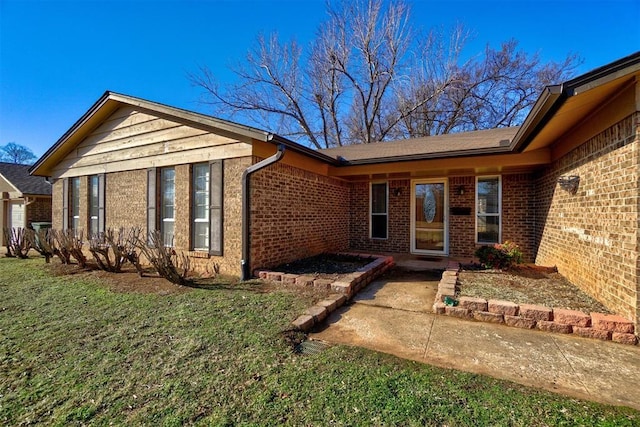 doorway to property with a lawn