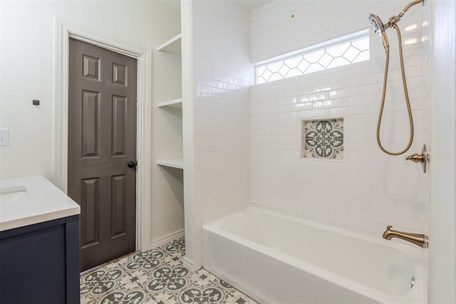 bathroom with tile patterned floors, tiled shower / bath combo, and vanity