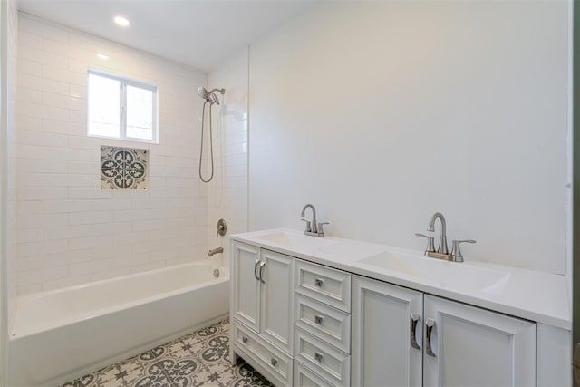 bathroom with tiled shower / bath combo and vanity