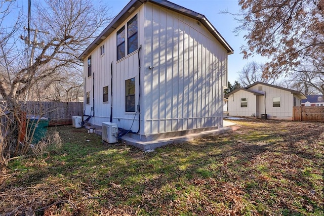 view of side of home with central AC