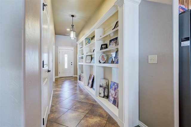 hallway with dark tile patterned flooring