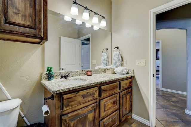 bathroom featuring toilet and vanity