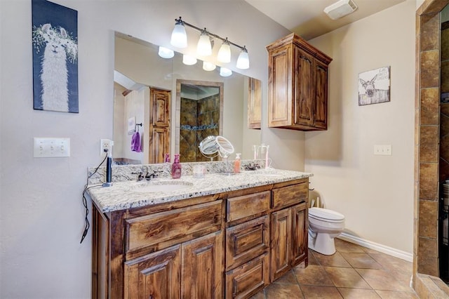 bathroom featuring toilet, vanity, tile patterned flooring, and a shower