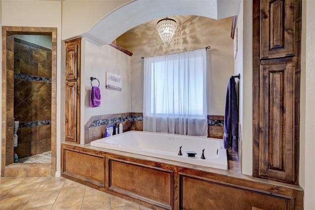 bathroom featuring tile patterned floors and separate shower and tub