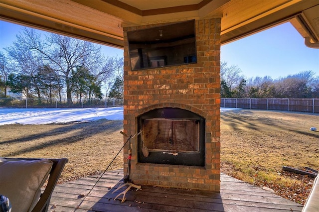 view of patio / terrace featuring an outdoor brick fireplace and a wooden deck