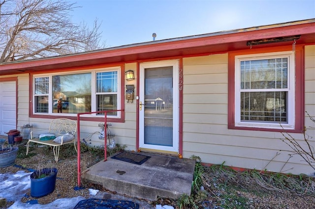 view of exterior entry featuring a garage