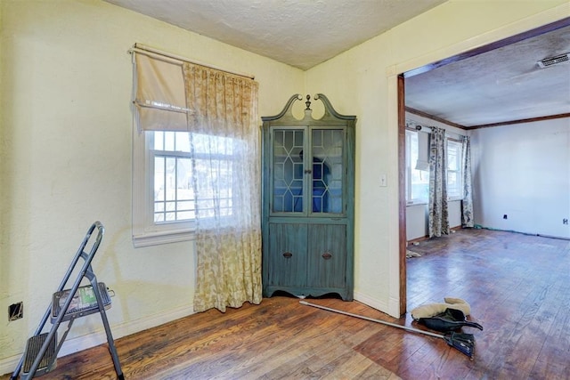 foyer entrance with a textured ceiling and dark hardwood / wood-style flooring