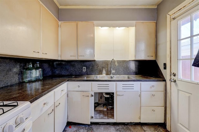 kitchen featuring decorative backsplash, sink, white gas range, and ornamental molding