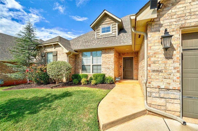 property entrance with a yard and a garage