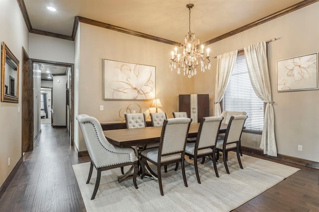 dining area featuring a notable chandelier, baseboards, wood finished floors, and ornamental molding