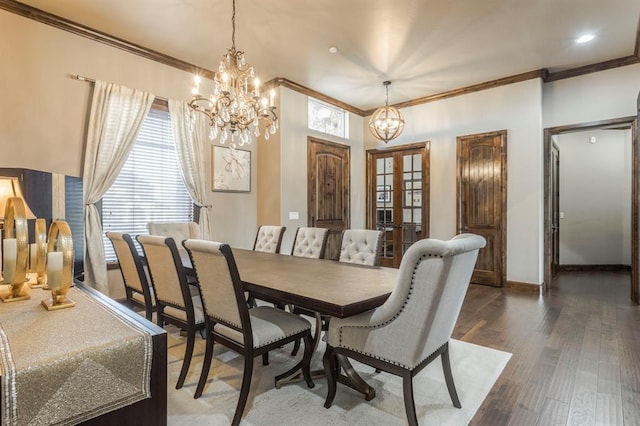 dining area with ornamental molding, dark hardwood / wood-style floors, a chandelier, and french doors