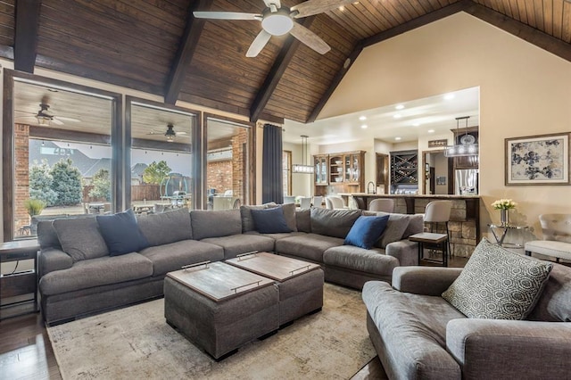 living room featuring high vaulted ceiling, beamed ceiling, wood-type flooring, sink, and wood ceiling