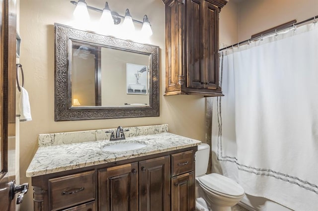 bathroom featuring vanity, toilet, and a shower with shower curtain