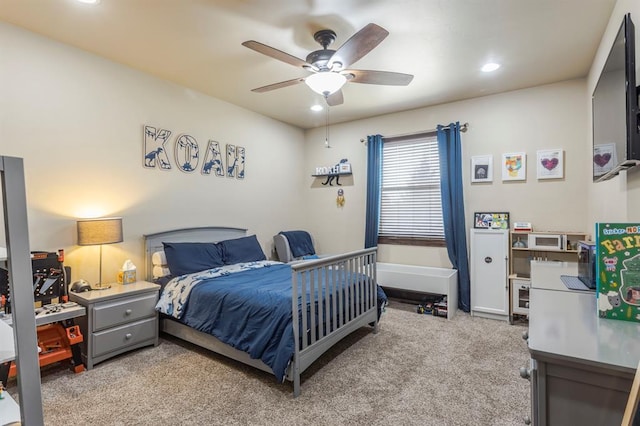 bedroom with ceiling fan and light colored carpet