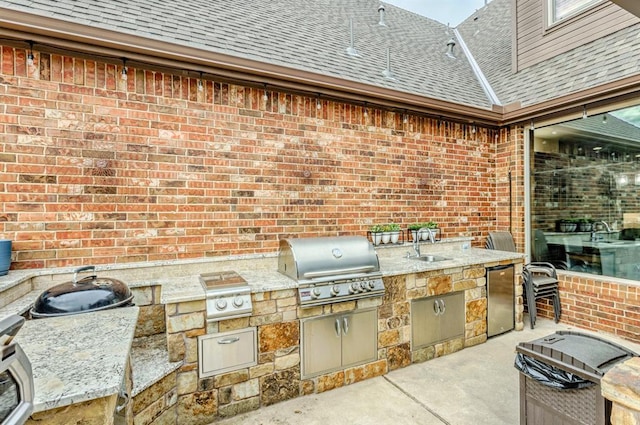 view of patio with grilling area, exterior kitchen, and sink