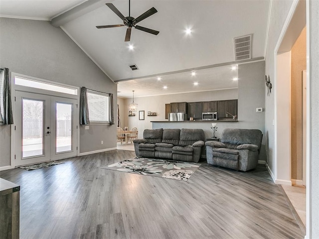 living room featuring french doors, light hardwood / wood-style floors, high vaulted ceiling, ornamental molding, and ceiling fan