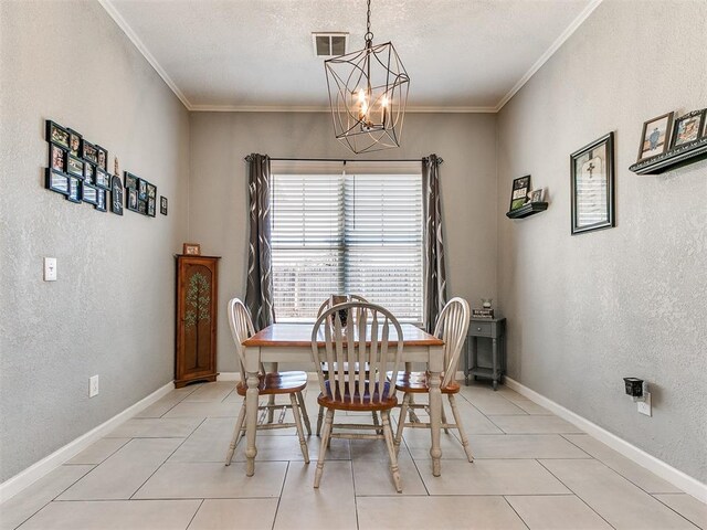 dining area with light tile patterned floors, ornamental molding, and a notable chandelier