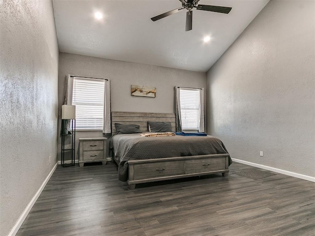 bedroom featuring ceiling fan, dark hardwood / wood-style floors, and multiple windows