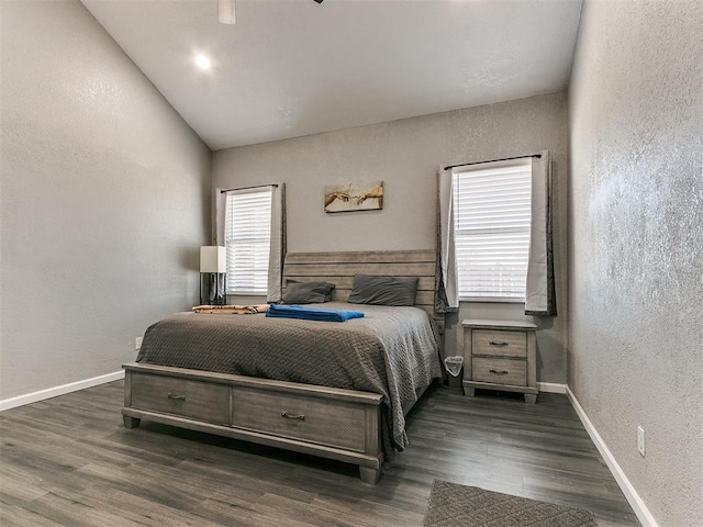 bedroom with ceiling fan, dark hardwood / wood-style flooring, lofted ceiling, and multiple windows