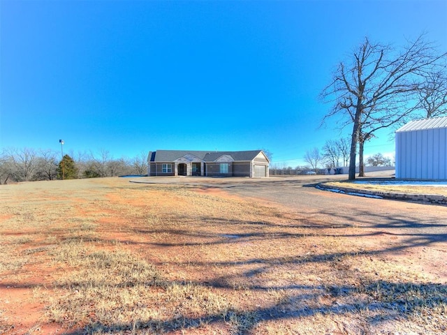 view of front of home with a front lawn and a garage