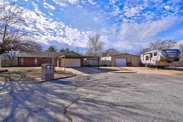 view of front of property featuring a garage, an outbuilding, and a carport