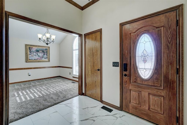 foyer featuring light colored carpet, a healthy amount of sunlight, and an inviting chandelier