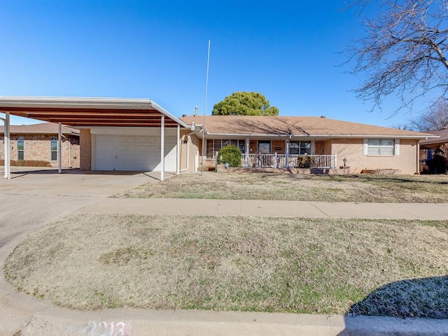 single story home with a garage, a carport, and covered porch