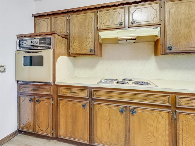 kitchen featuring white cooktop and wall oven