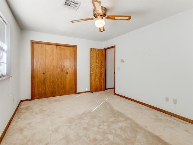 unfurnished bedroom featuring ceiling fan, carpet flooring, and a closet