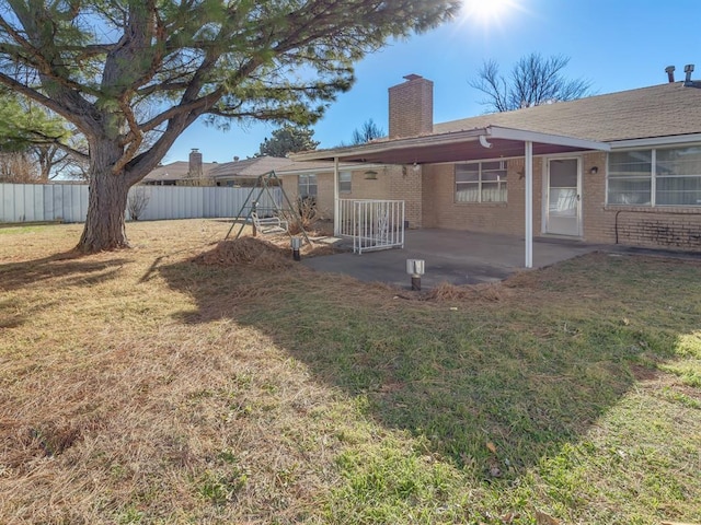 rear view of property with a patio area and a yard