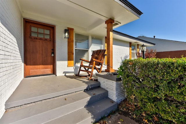 view of exterior entry with covered porch