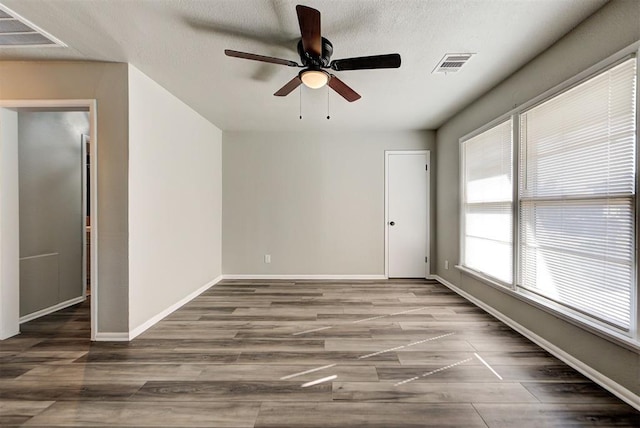 spare room featuring ceiling fan and dark hardwood / wood-style flooring