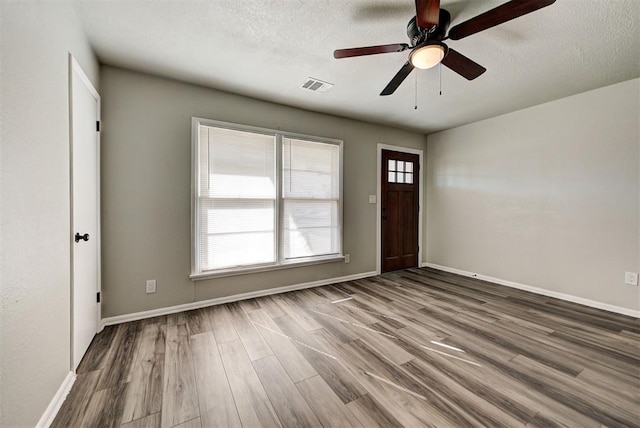 entrance foyer featuring ceiling fan, a textured ceiling, and hardwood / wood-style floors