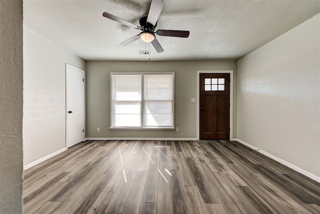 foyer entrance featuring a textured ceiling, ceiling fan, and hardwood / wood-style floors