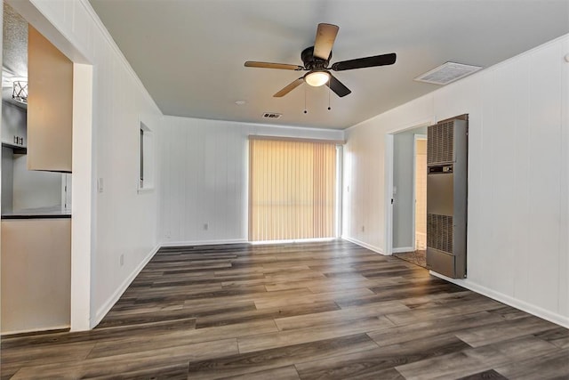 empty room featuring ceiling fan and dark hardwood / wood-style flooring