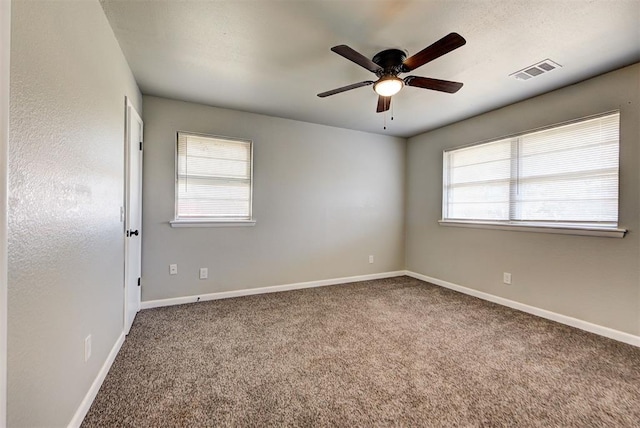 unfurnished room with ceiling fan and carpet floors