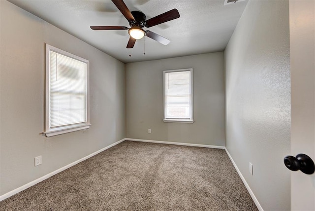 spare room with carpet floors and ceiling fan