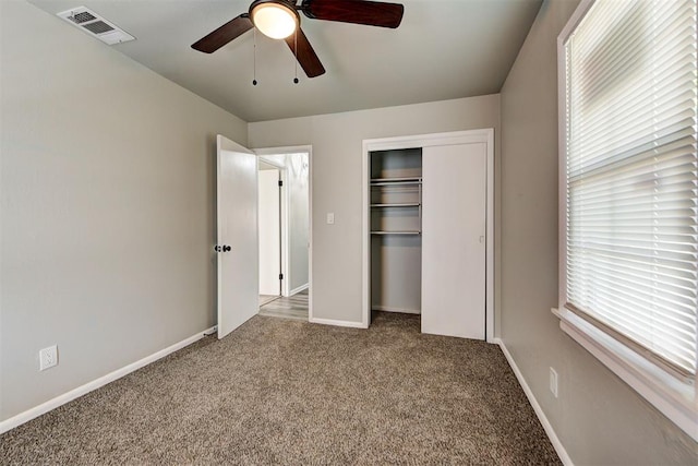 unfurnished bedroom featuring ceiling fan, a closet, and carpet floors