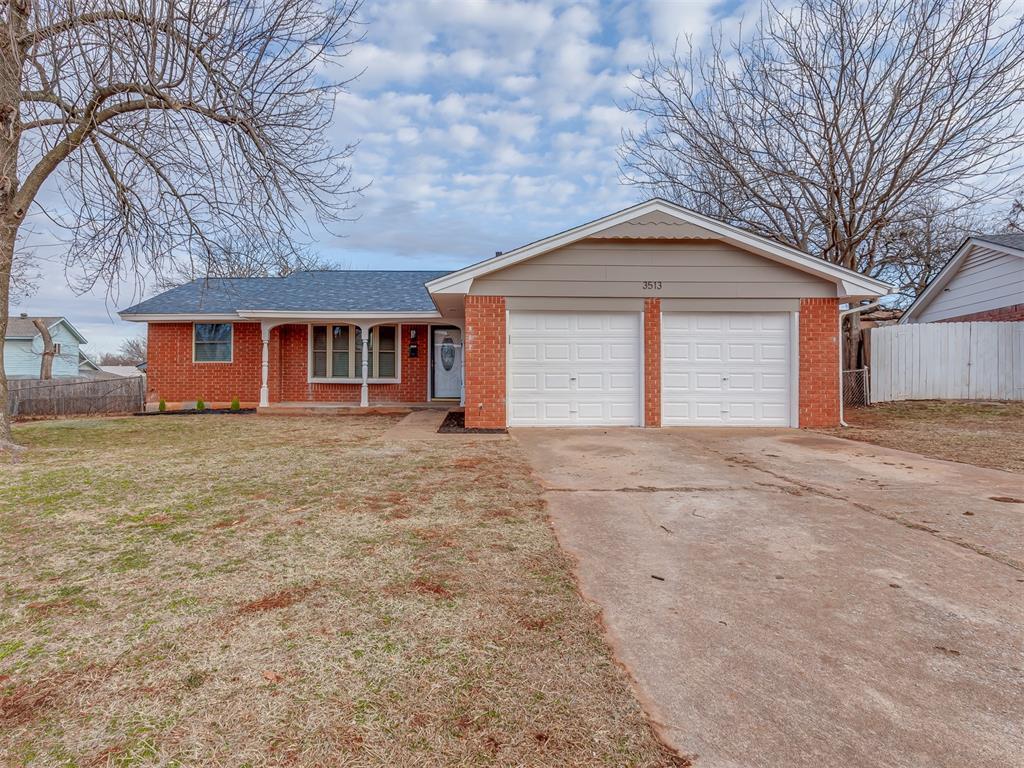 single story home featuring a front yard and a garage