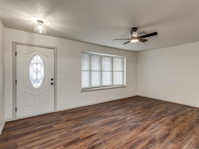 foyer with a textured ceiling, ceiling fan, and dark hardwood / wood-style flooring