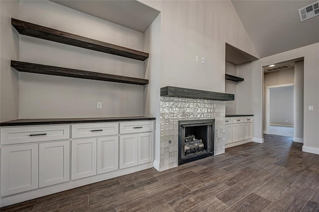 unfurnished living room with a stone fireplace