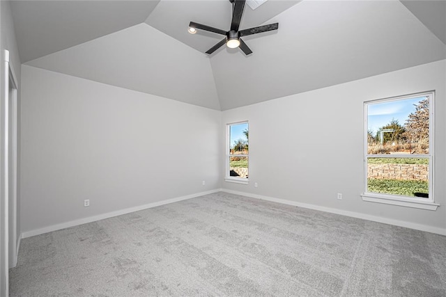 spare room featuring ceiling fan, light colored carpet, and lofted ceiling